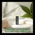 Peppermint natural lip balm on a light surface with green leaves in the background