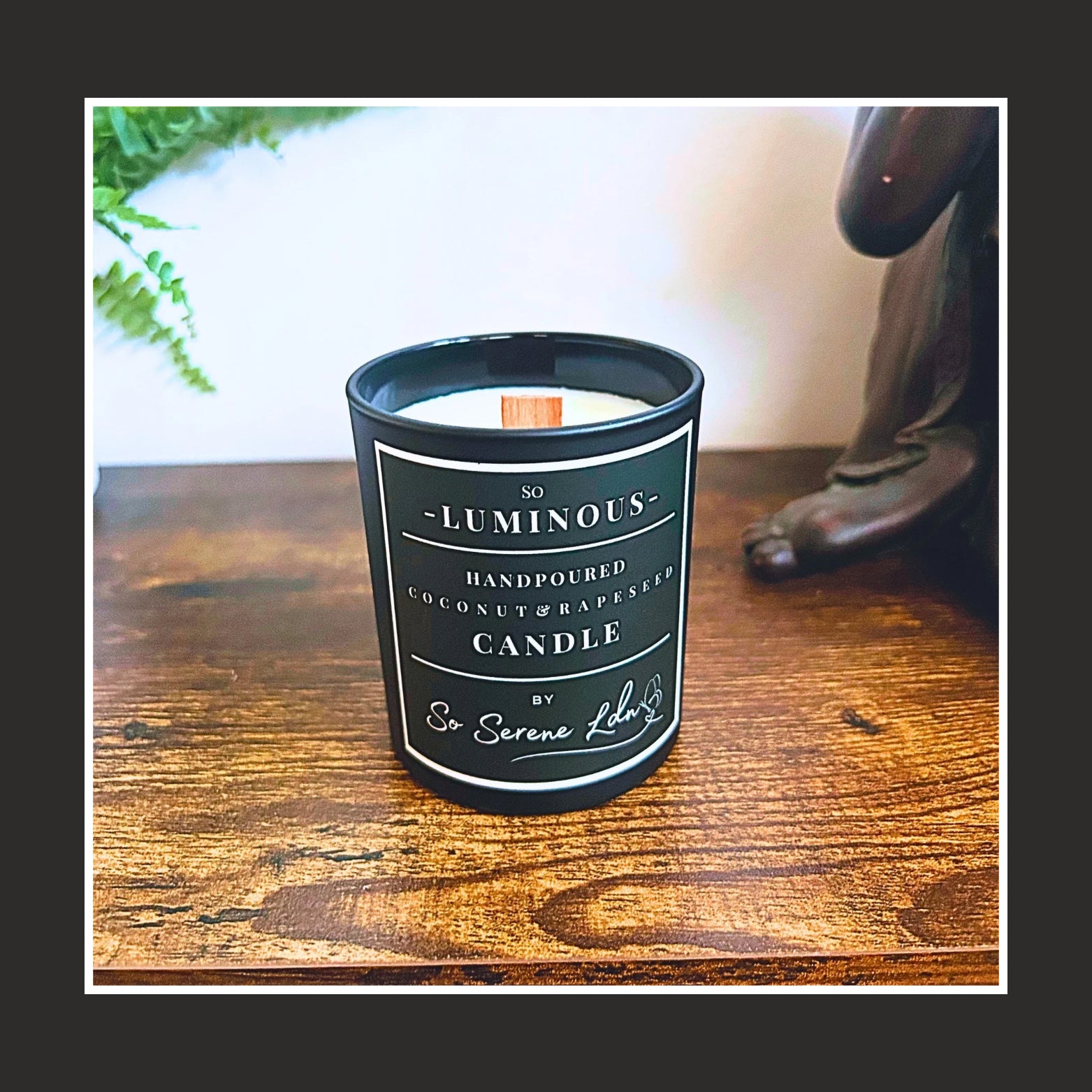 So Luminous  natural plant based wax Candle on a wooden surface