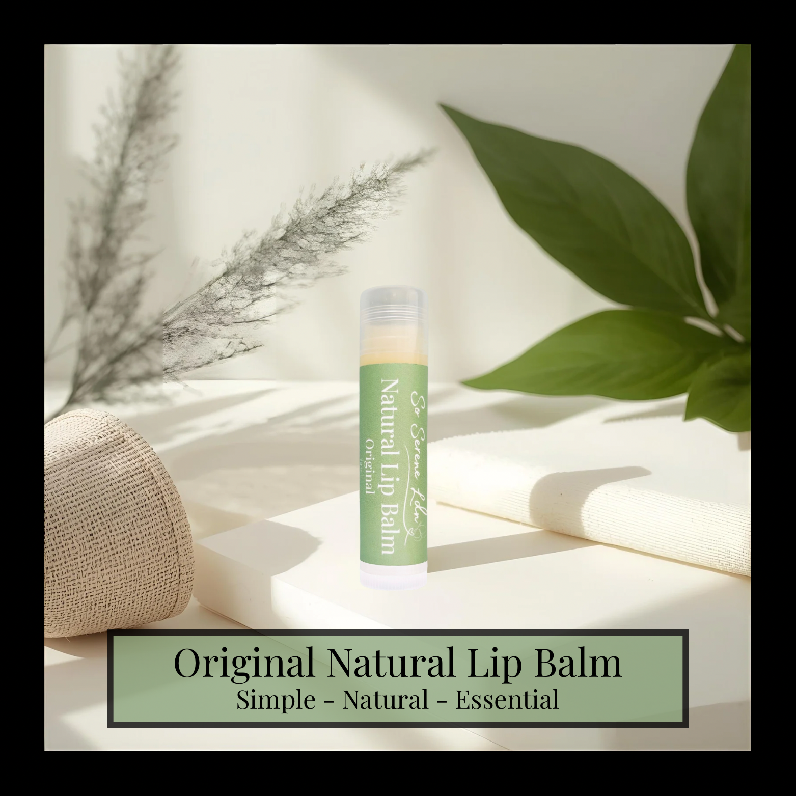 Natural lip balm on a light surface with green leaves and a woven basket in the background